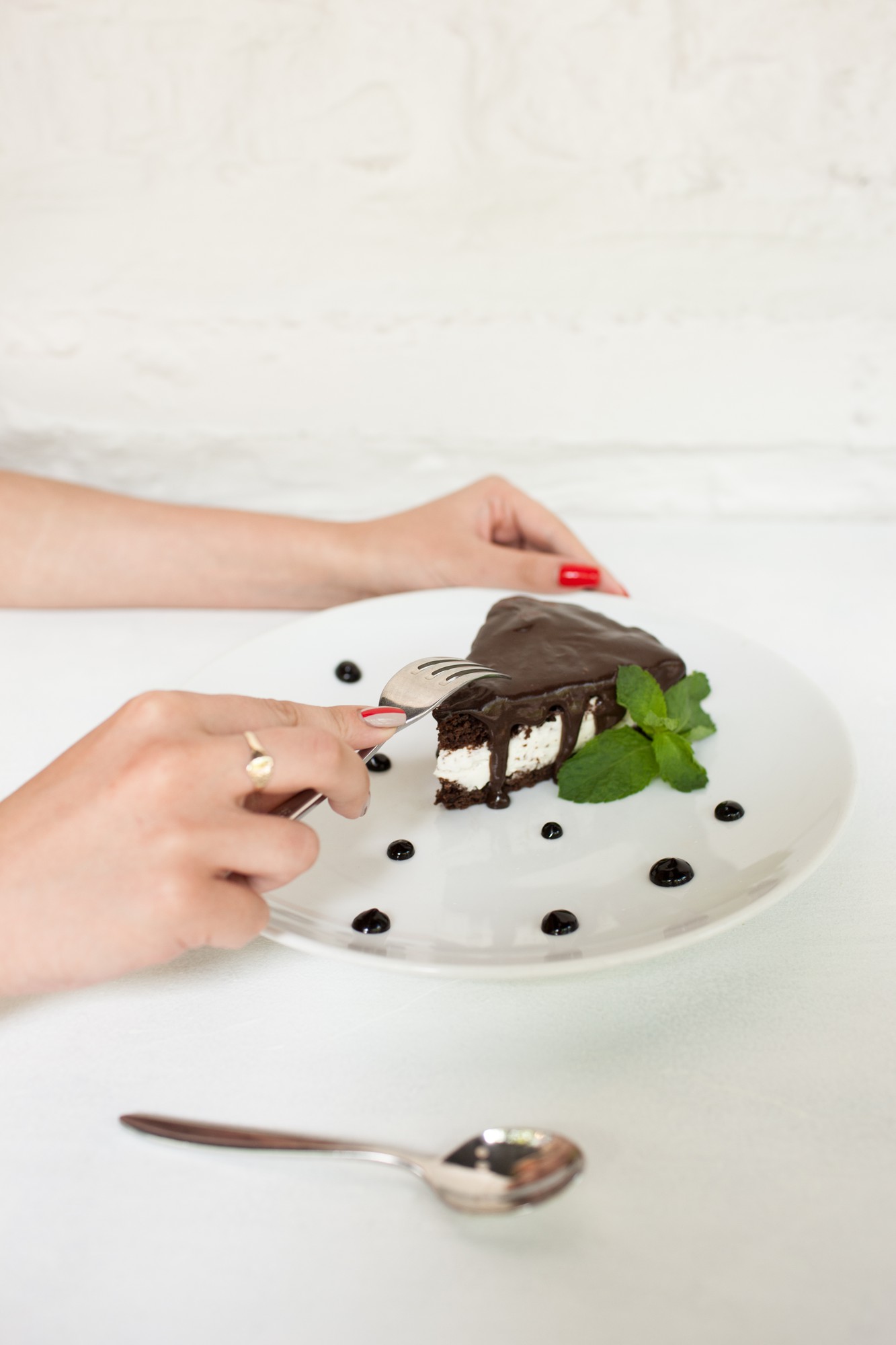 Close up of hands garnishing dessert